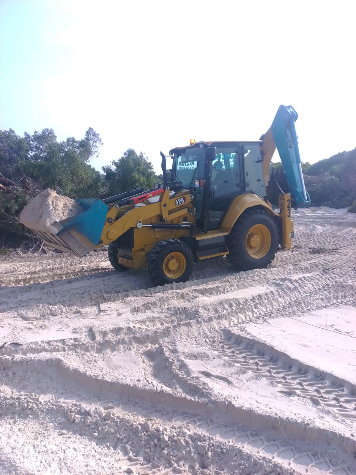 CAT TLB carrying sand during earthworks